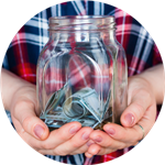 girl holding jar with cash